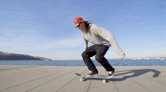 Animated GIF showing a skateboarder doing a flip on a skateboard that has a neon line outlining it