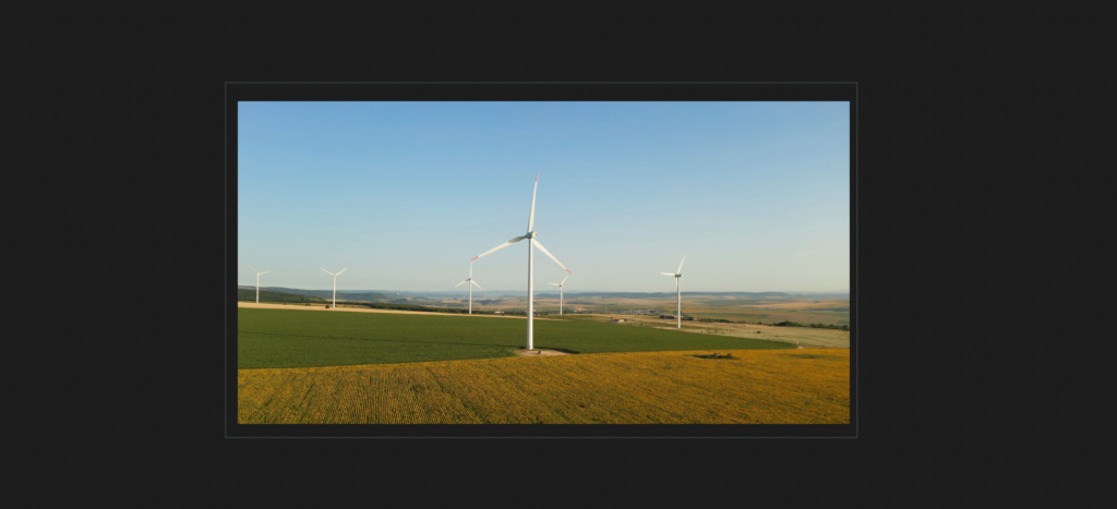 Screenshot showing a footage clip of a field of windmills inside of a composition in after effects