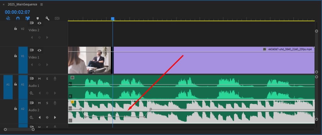 Premiere Pro's Timeline, showing the audio level ducking below the audio by 18.5 dB.